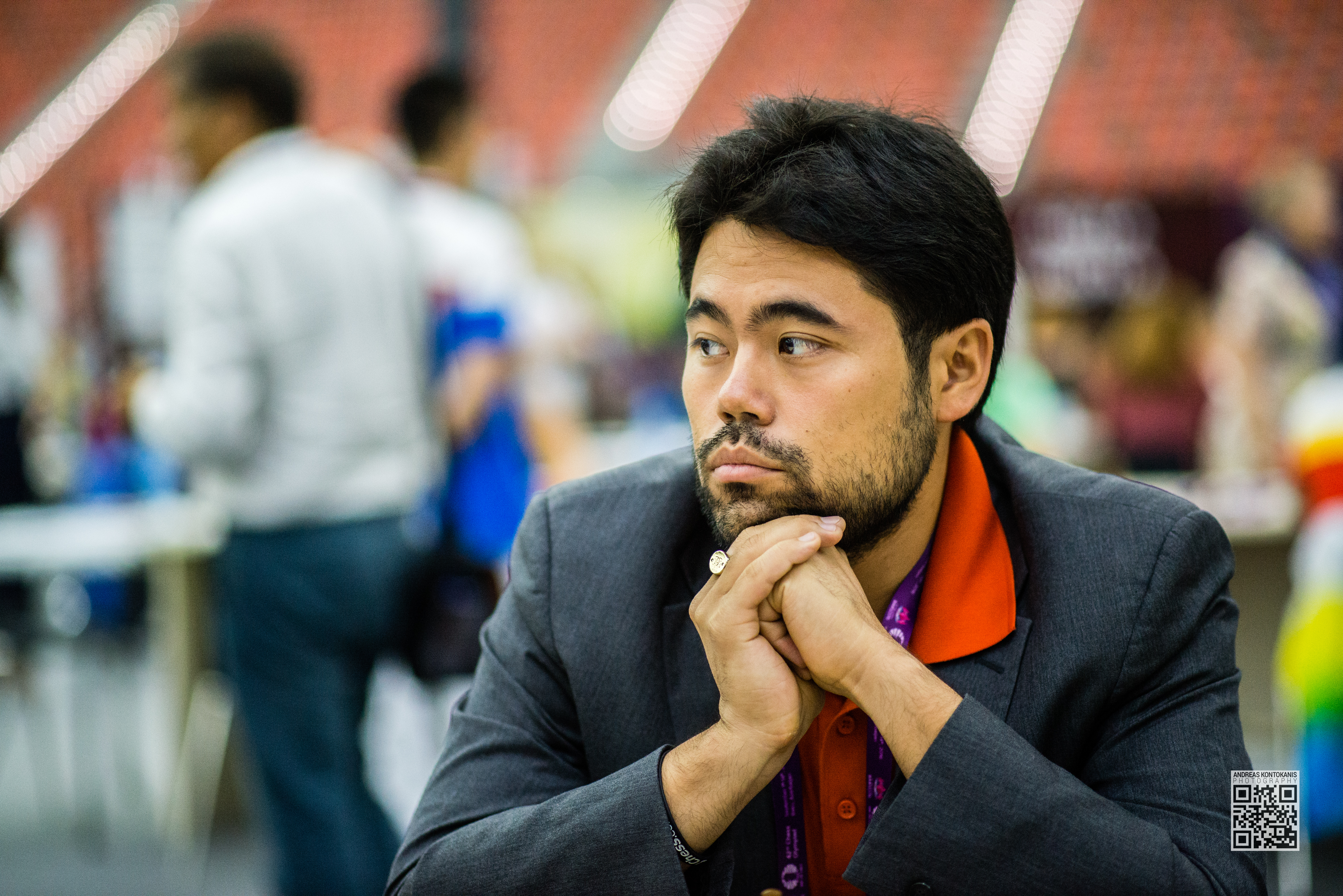 Nakamura Hikaru wearing a suit looking off into the distance